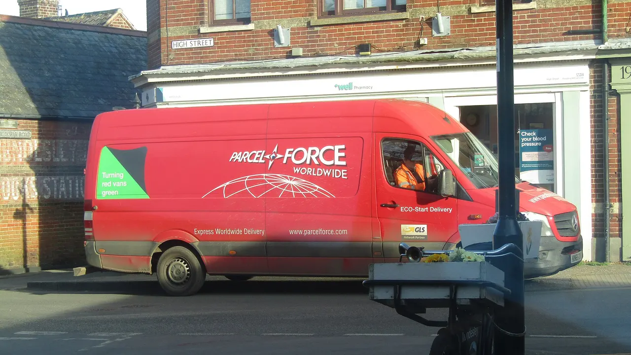 A red Parcelforce Worldwide van marked ECO-Start Delivery is parked beside a brick building on a street with a High Street sign.